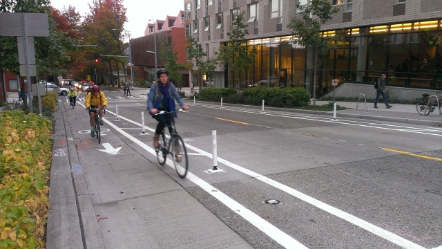 Bicyclists ride the new protected bike lanes on northbound Brooklyn Avenue NE. (Photo by the author)